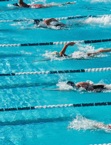Fitness first members having a swimming race Fitness first members having a swimming race