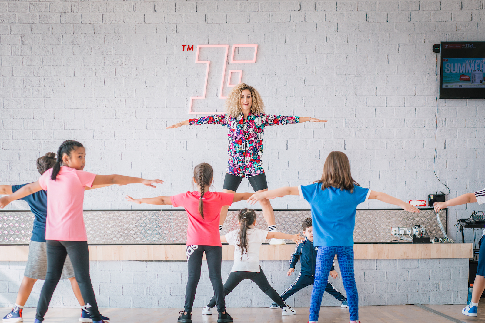 Fitness First coach instructing kids Fitness First coach instructing kids