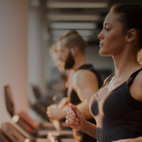 membership packages Female Gym member running on treadmill in Fitness First UAE
